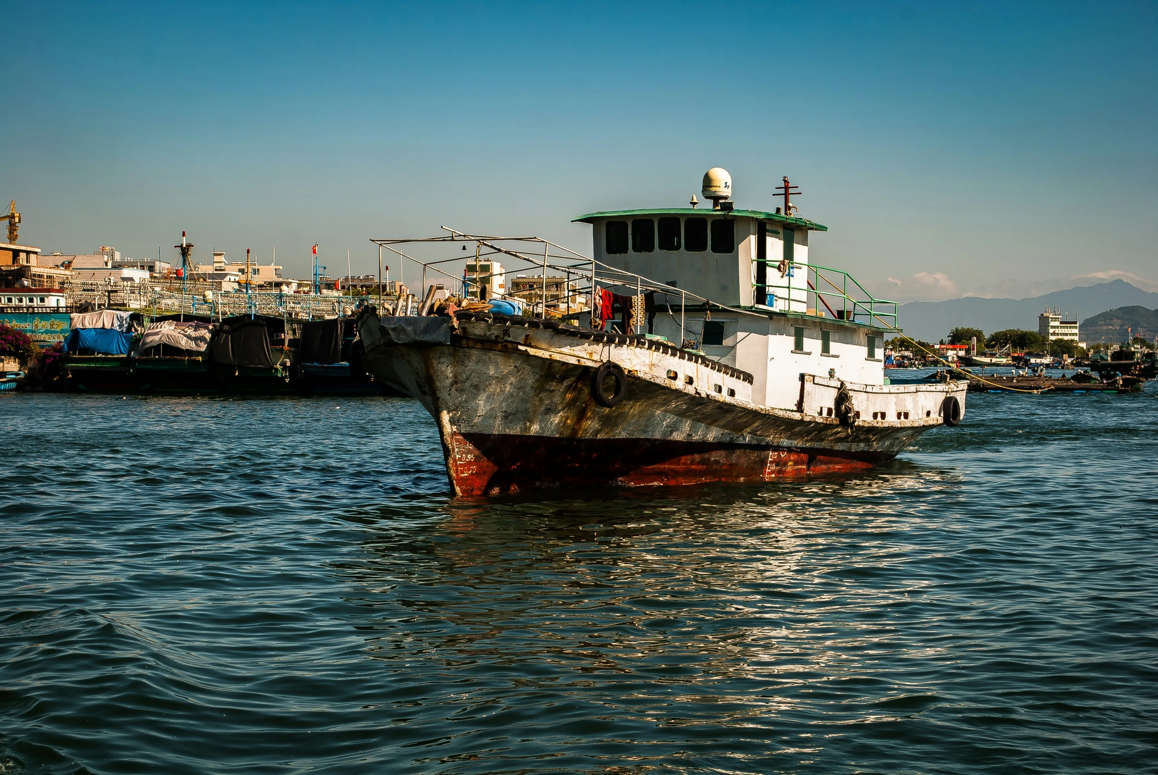 an old, rusty boat is in the water