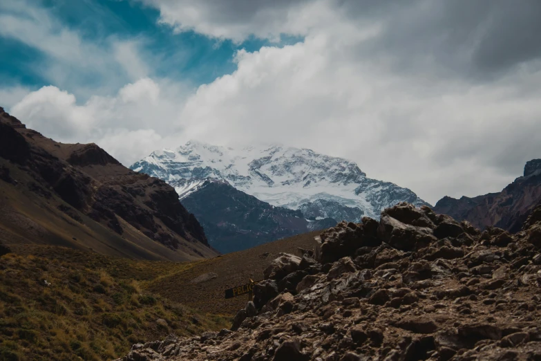 mountains, rocks, and clouds in the distance