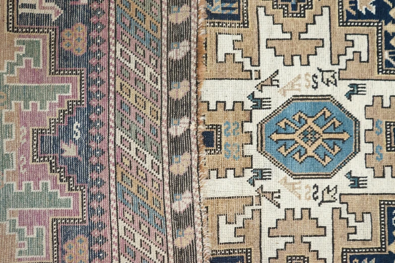 an old carpet with several design in different colors