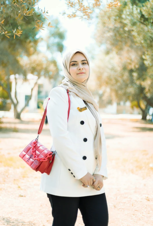 a girl dressed in a hijab and jacket