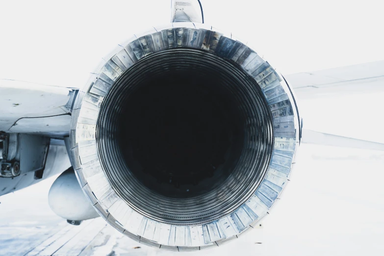 a jet engine sitting next to an airplane