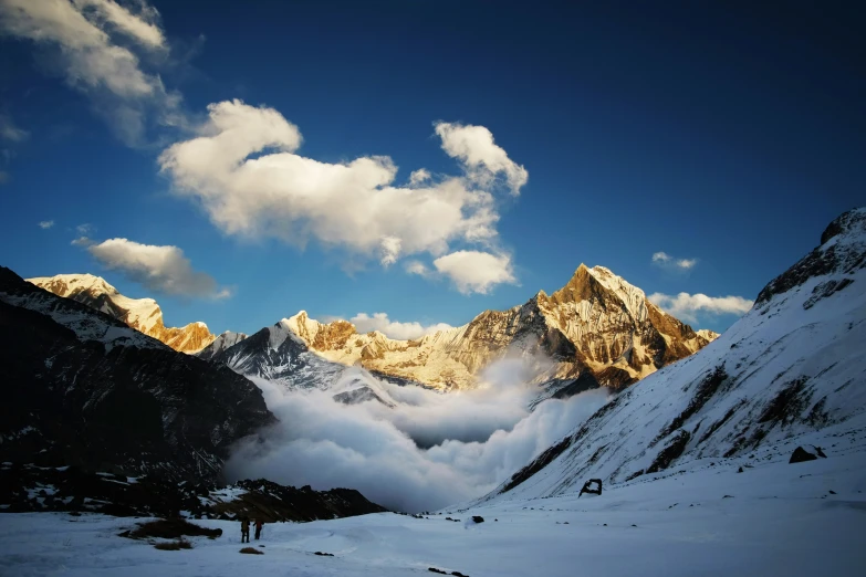 a snowy landscape with a group of mountains in the background