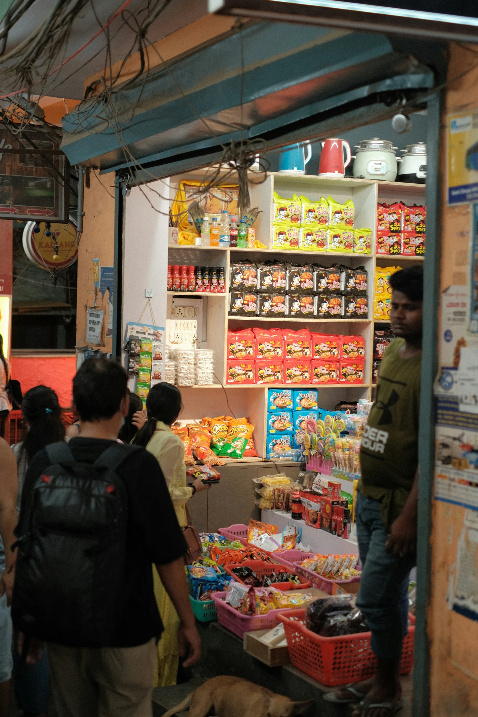 two people walking by a store that sells goods