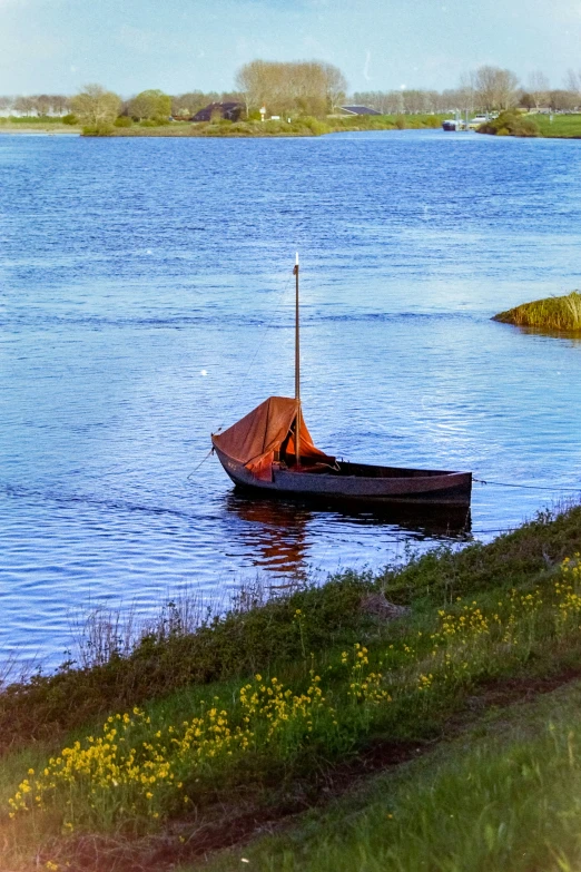 a small boat that is floating on some water