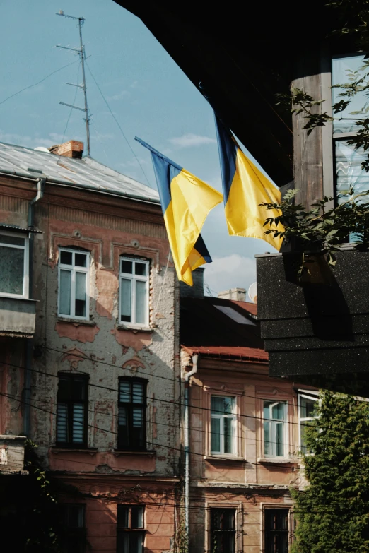 a building with a clock tower and a flag flying in the wind