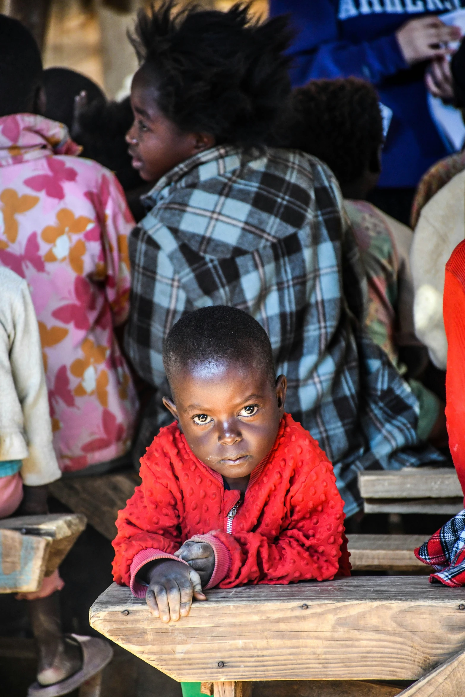 a small child is sitting at a school desk