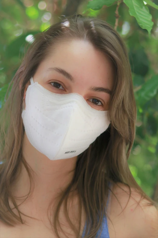 girl with face mask on wearing a nose muff