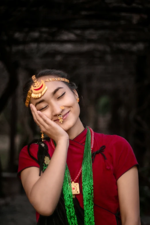 a girl with green necklaces standing outside and smiling