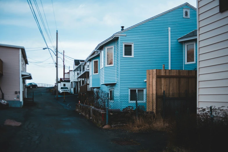 two houses are shown, one is painted blue