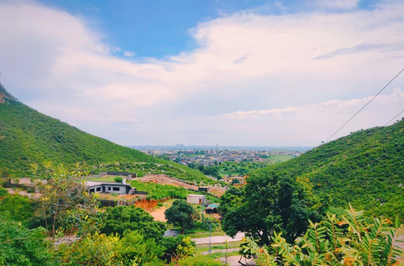 a scenic view of houses, trees and a mountain range