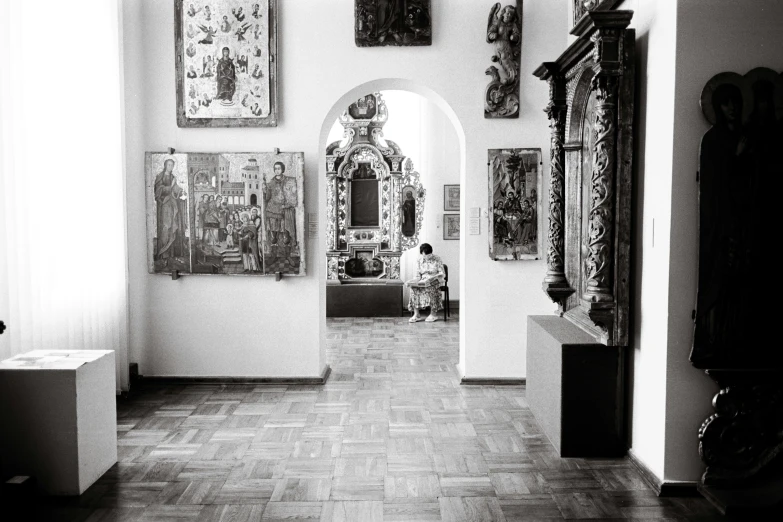 an entrance to a building with many paintings on the wall