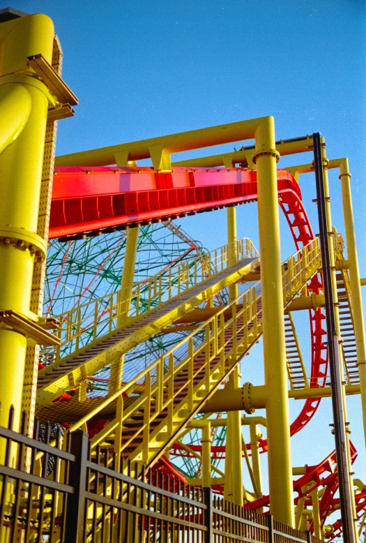 a yellow fireman's ladder with blue sky in the background