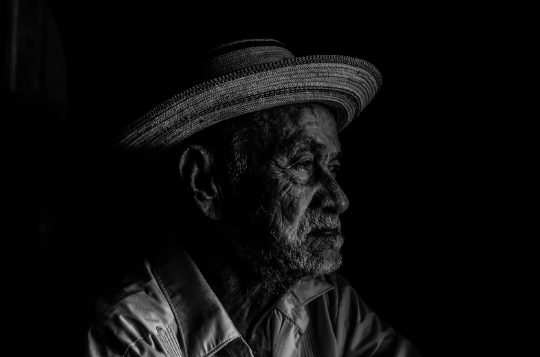 a man wearing a hat stands in front of the camera