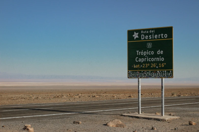 a green sign on the side of the road