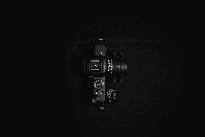 a dark background with black film cameras on it