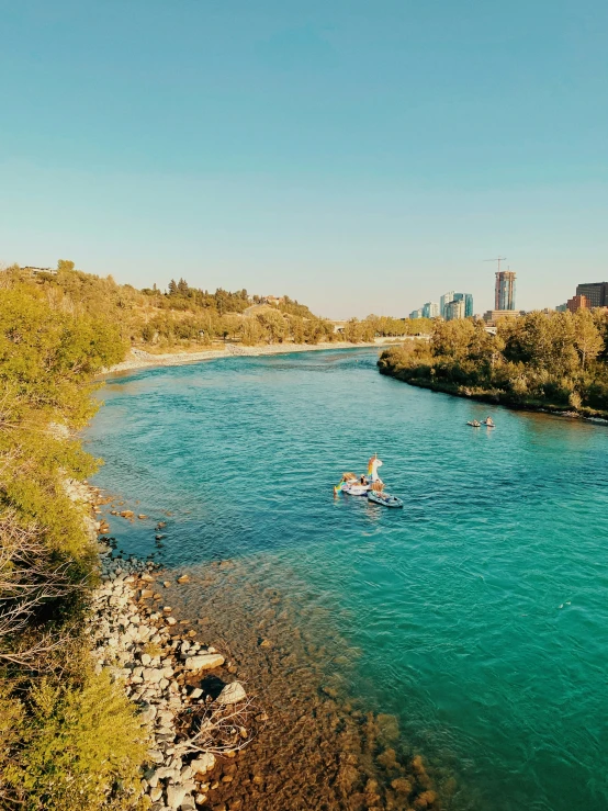 there are people on their kayaks in the river