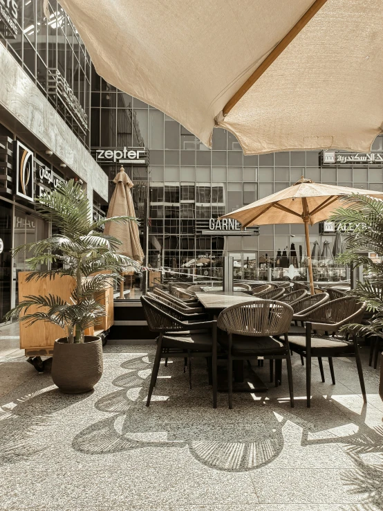 an outdoor patio with tables, chairs and umbrellas