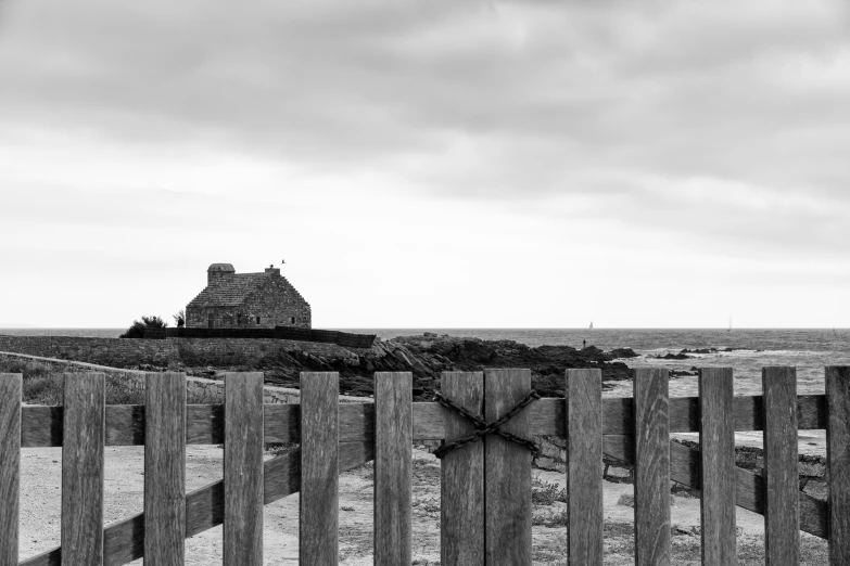 a wooden fence and a building in the distance