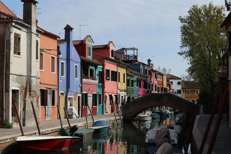 several colored houses lining both sides of the waterway