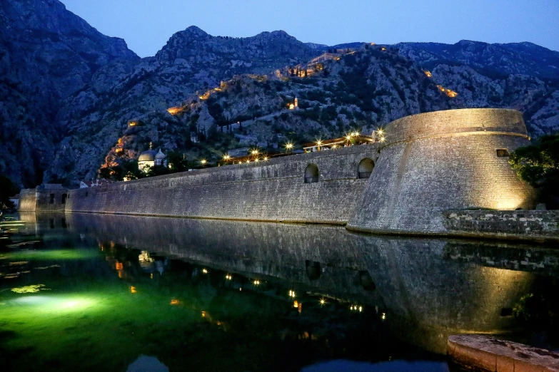 water next to a mountain in the evening