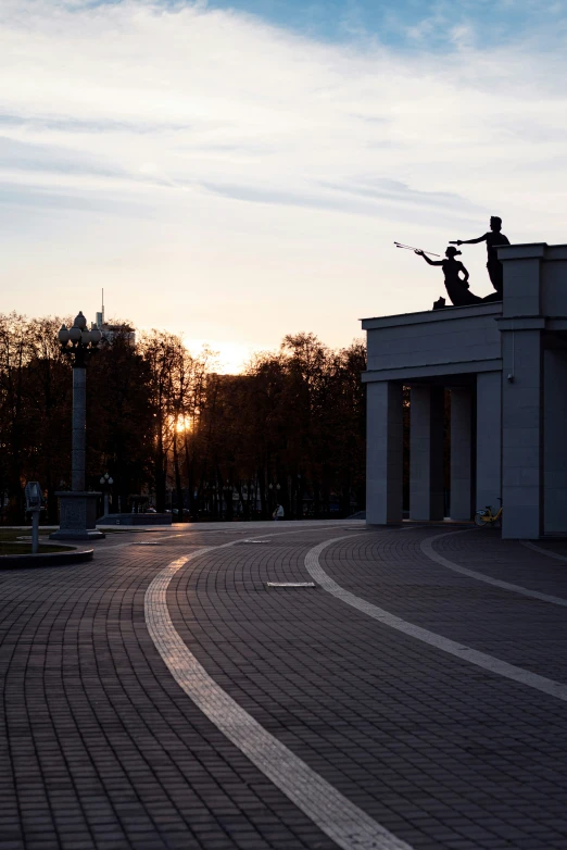 two statues that are standing on top of a pillar