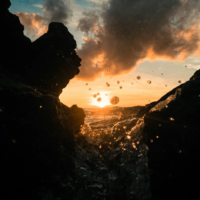 water coming from the ocean and leaving a path of bubbles