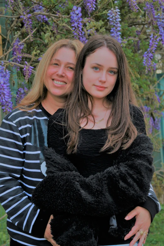 two girls in striped shirts standing next to each other