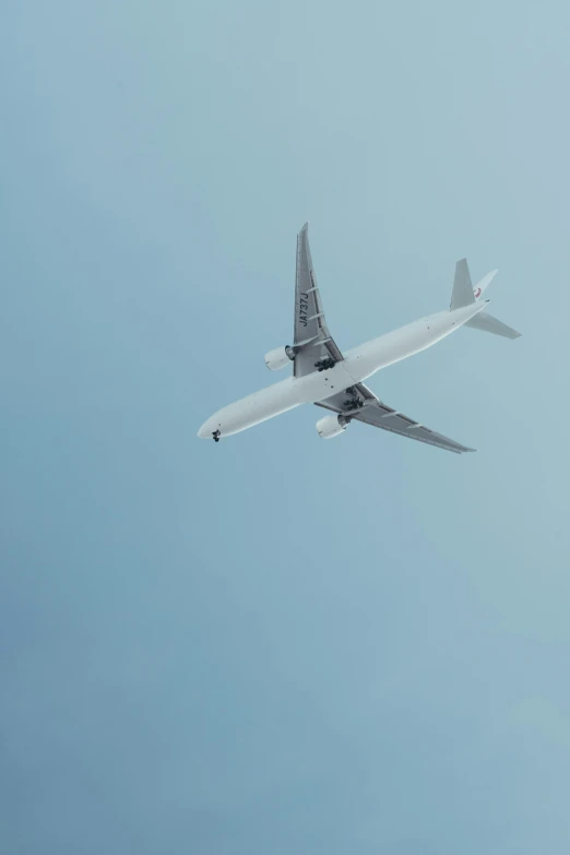 an airplane is flying across the blue sky