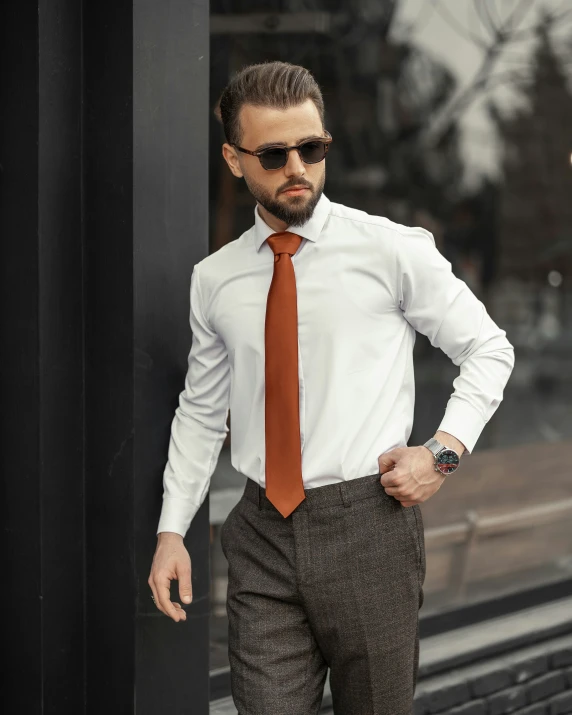 a man in a dress suit, tie and sunglasses