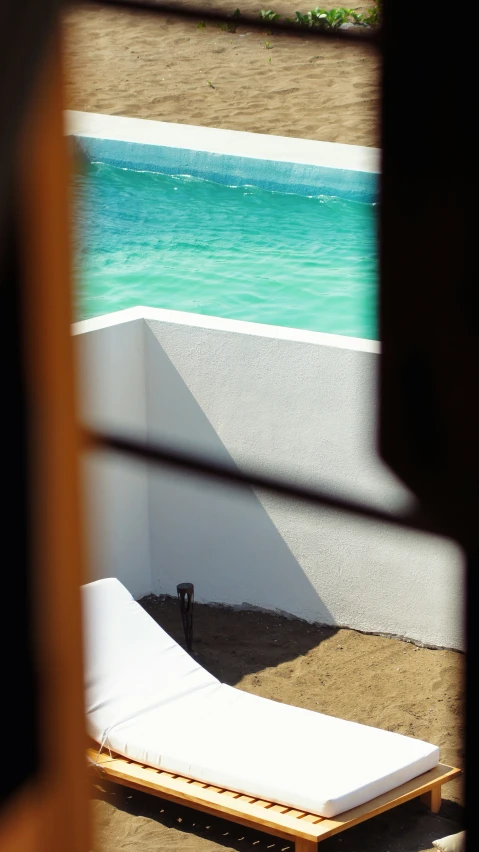 a empty swimming pool next to the beach