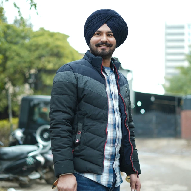 a man wearing a hat and a quilted jacket