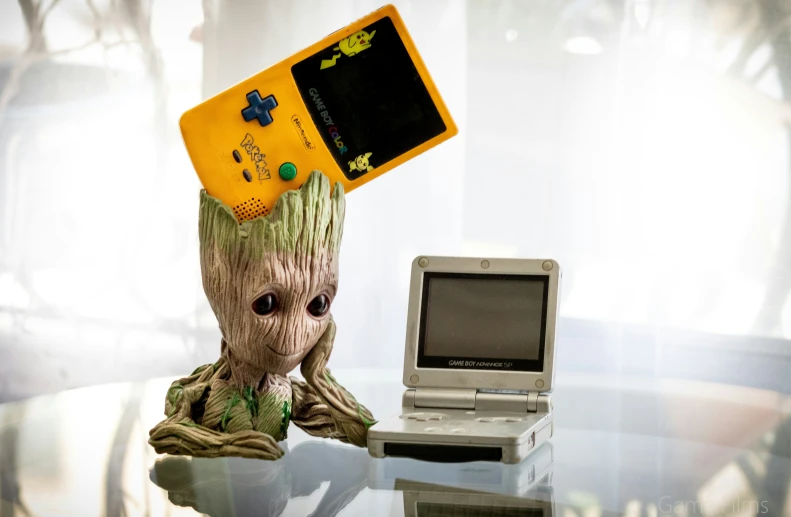 a figurine with a yellow game pad sitting on top of it