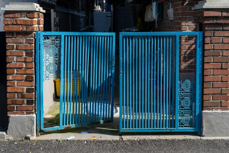 the iron gate with bars is opening up to allow access