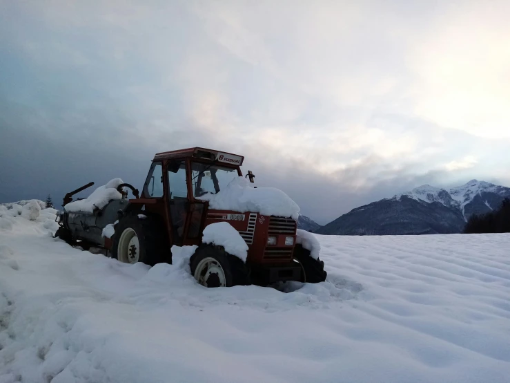 a truck parked on top of a snow covered mountain