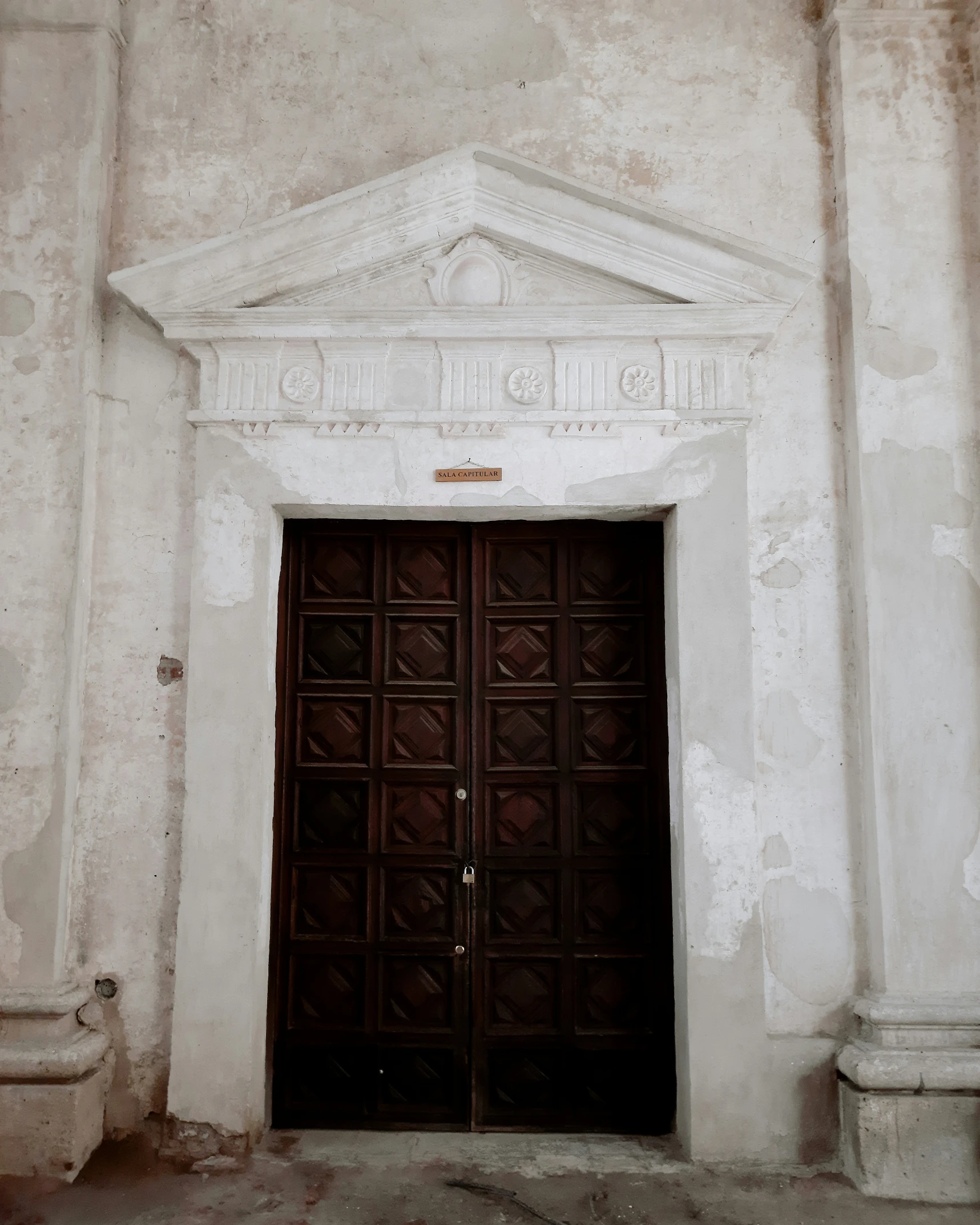 an old doorway with ornate decorations at the bottom