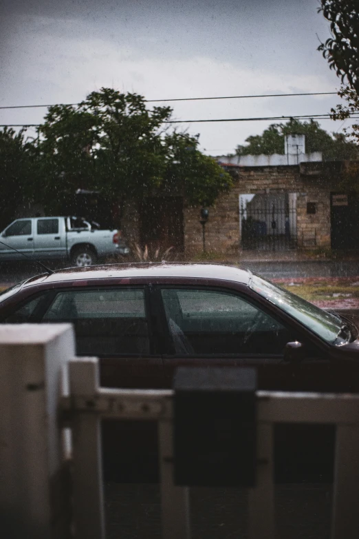 two cars parked in a lot next to houses