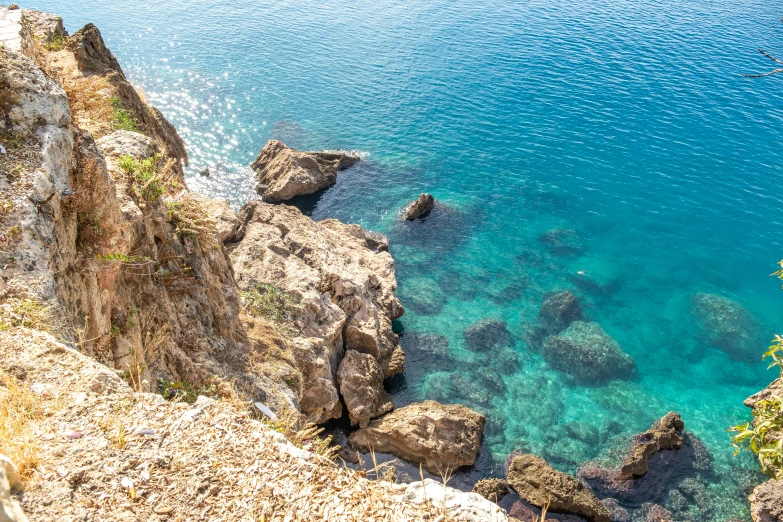 the view of water and rocks on a sunny day