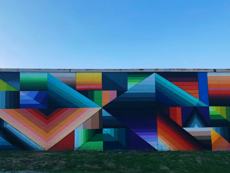 a colorful wall covered in different colored triangles