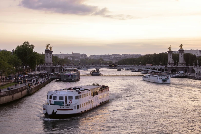 a river boat passes in front of several other boats