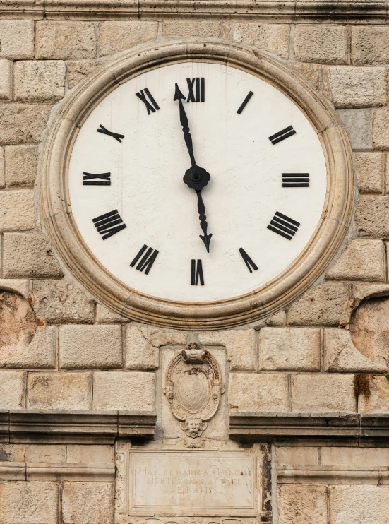 a clock mounted on the side of a brick wall