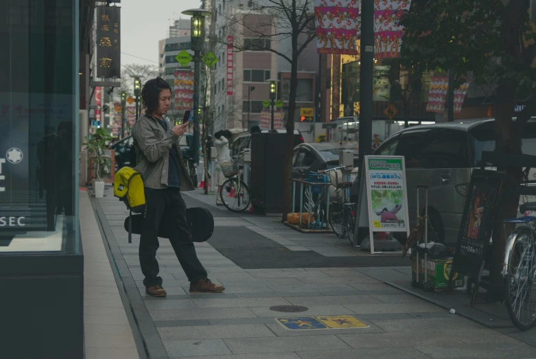 the woman is walking down the city street talking on her phone