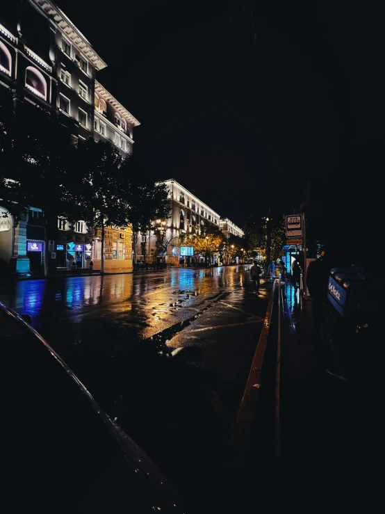 a rainy night in the town square with a clock on it