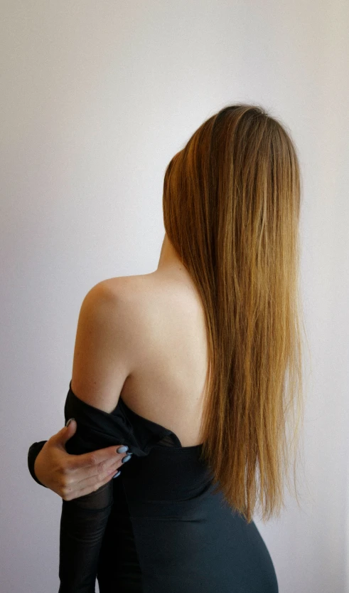 a woman with very long red hair wearing a black top