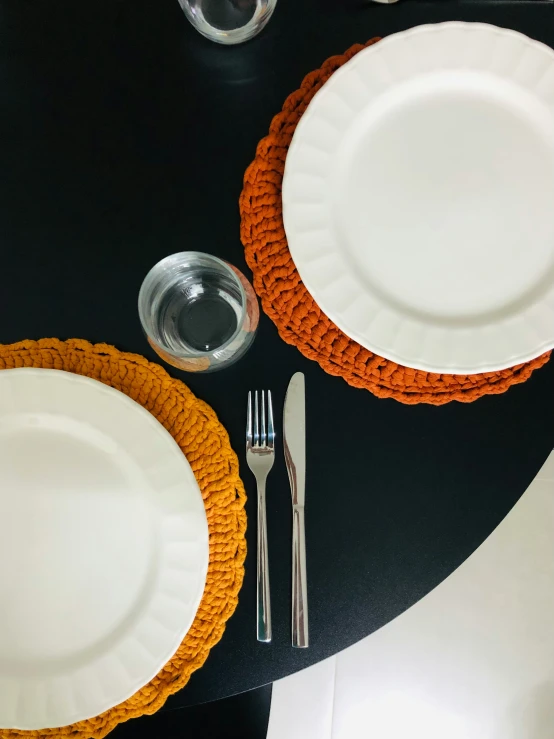 there is a plate, knife, fork and glass setting on the table