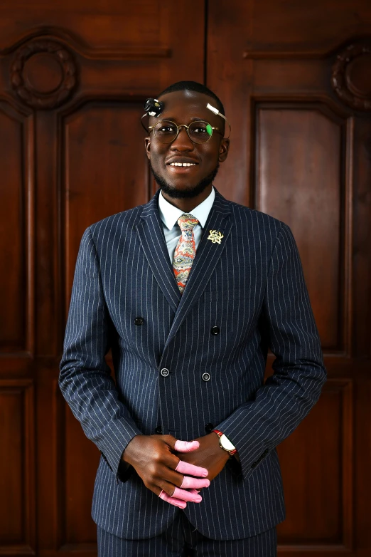 a man in a blue suit and tie wearing sunglasses