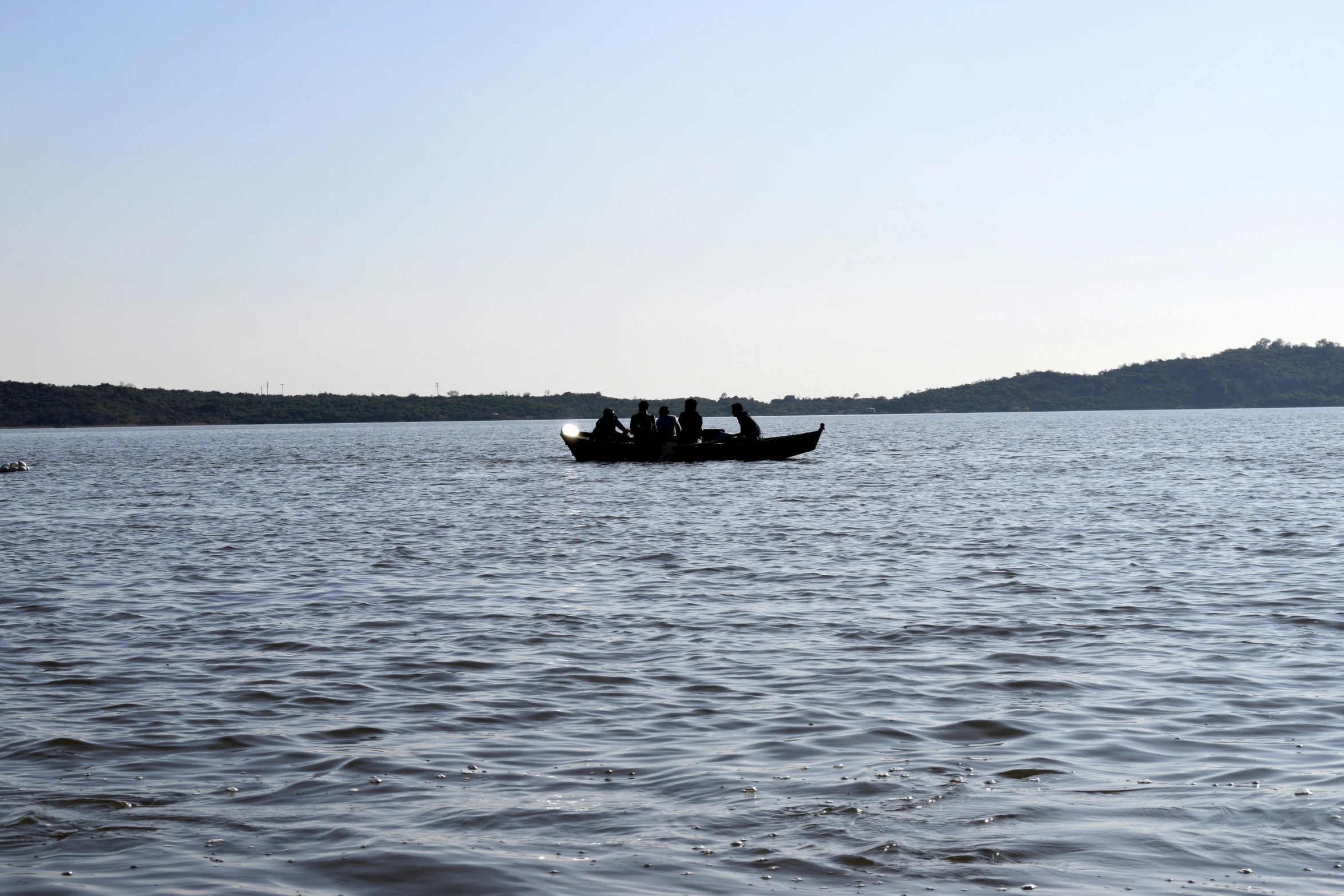 people on a boat riding in the water