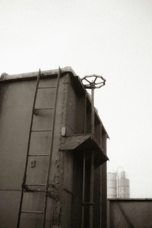 black and white pograph of a dumpster with a clock tower