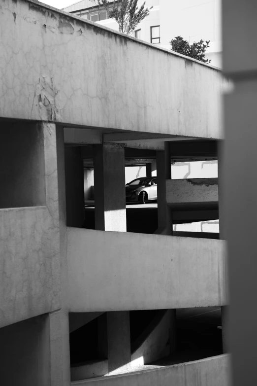 the view out the window of a high rise building shows some traffic and cars