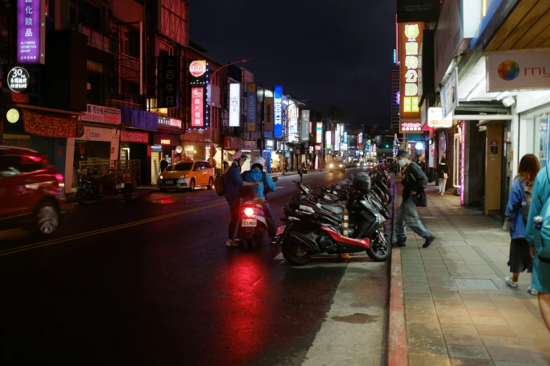 a man on his motor cycle at the end of a city street