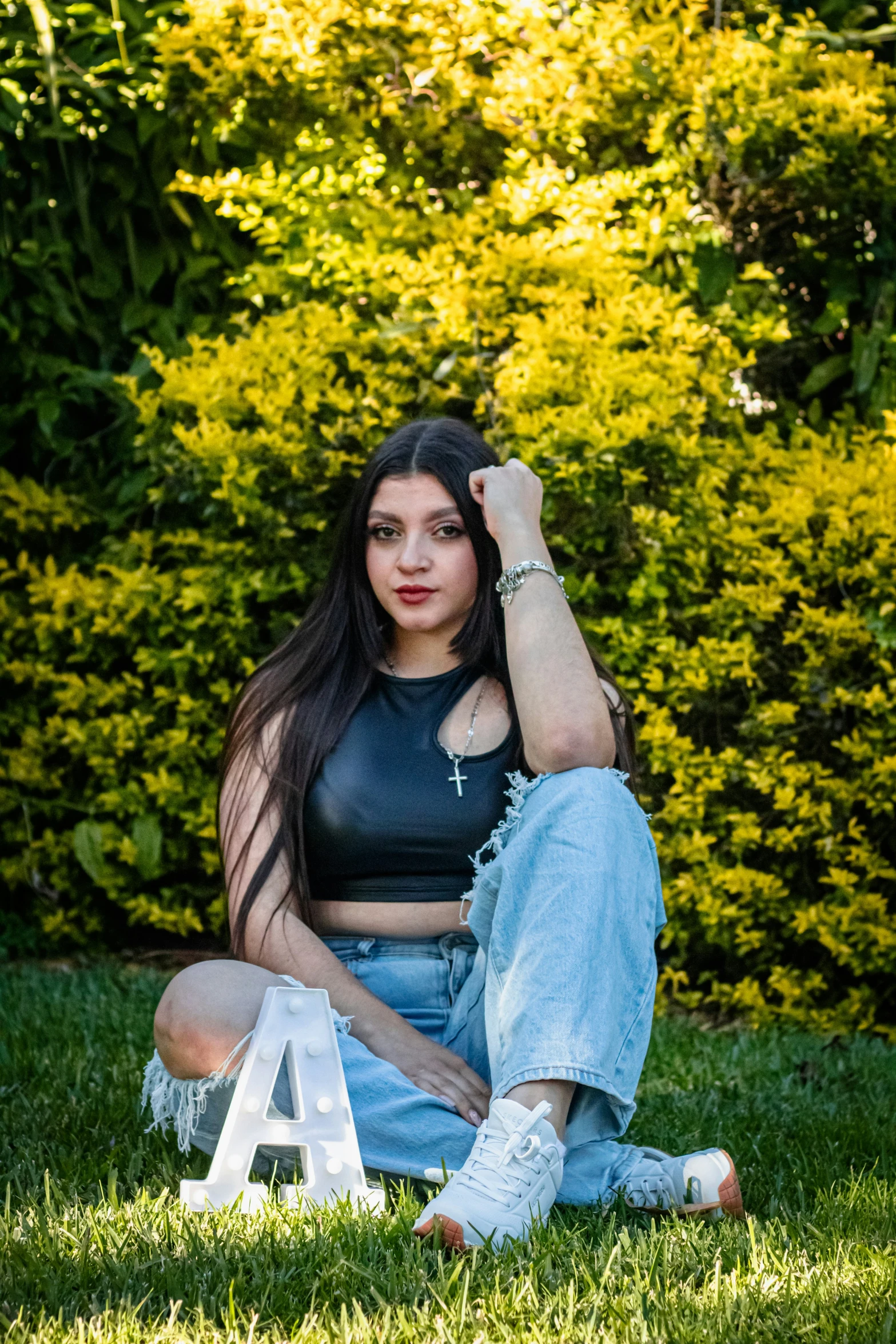 a beautiful young woman posing on the grass